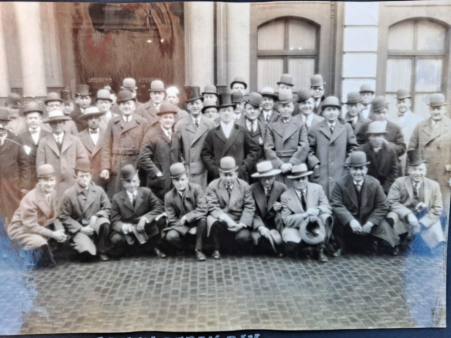 Black and white group photo, people with hats and coats