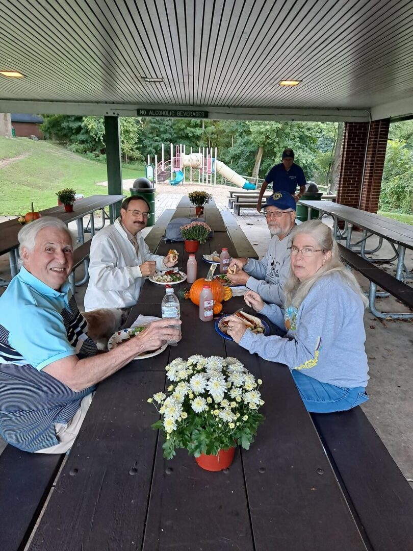A Group of Elderly People Eating by a Table