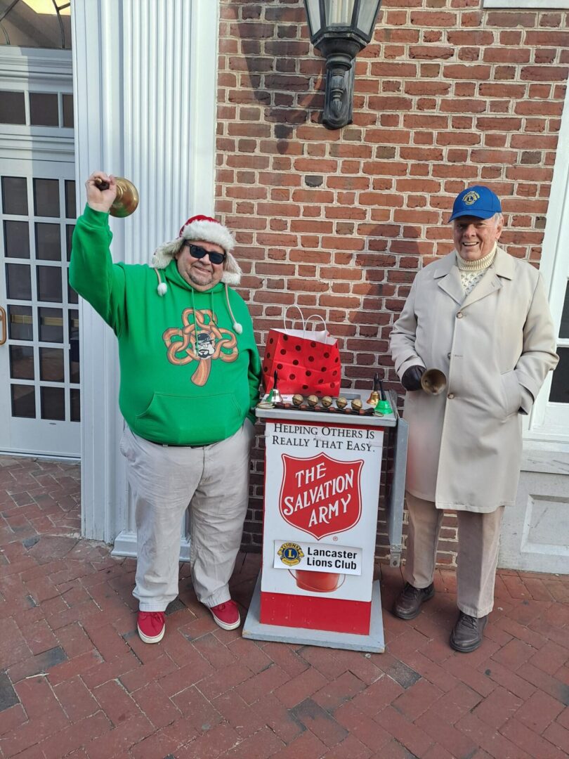 Two men standing at the salvation army box