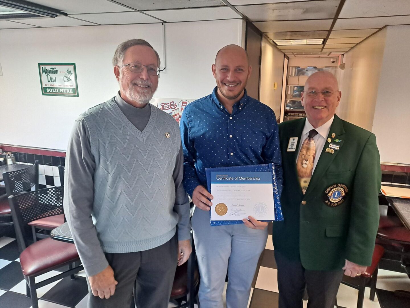 Two men Handing Over a Certification to a Man