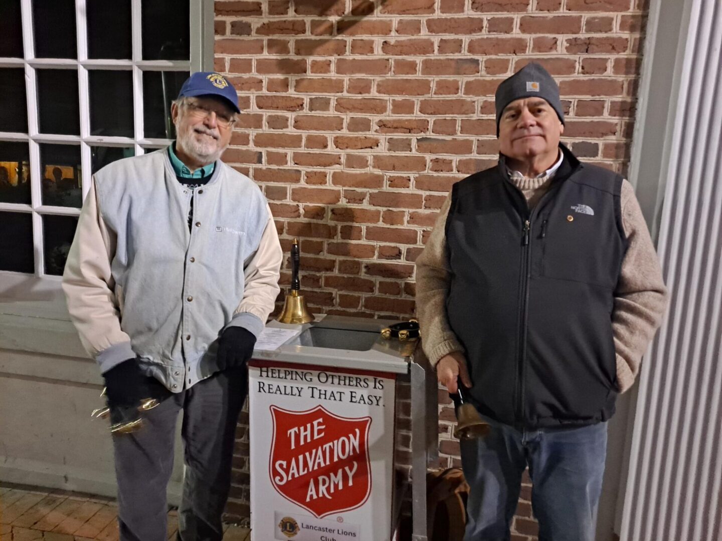 Two Men Standing With a Salvation Army Stand